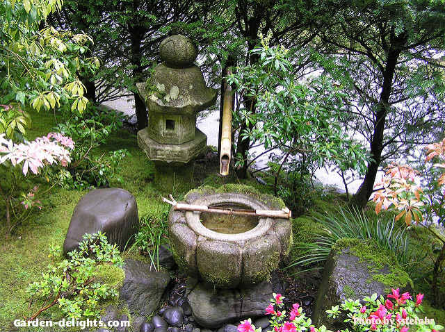  Small stone Japanese water fountain in garden with bamboo reed pouring water into bowl and small Japanese Garden Temple accent aside with surrounding colorful flowers, Japanese bamboo water fountain kits, feng shui Japanese fountains, Odishi fountain, Japanese Zen fountains, bamboo water feature, Shishi Odoshi water fountain, meditation garden fountain, fountain moss, backyard inspiration, landscaping Asian. Create your own peaceful garden retreat to escape from the daily rush of life. Shofuso Japanese house water fountain.